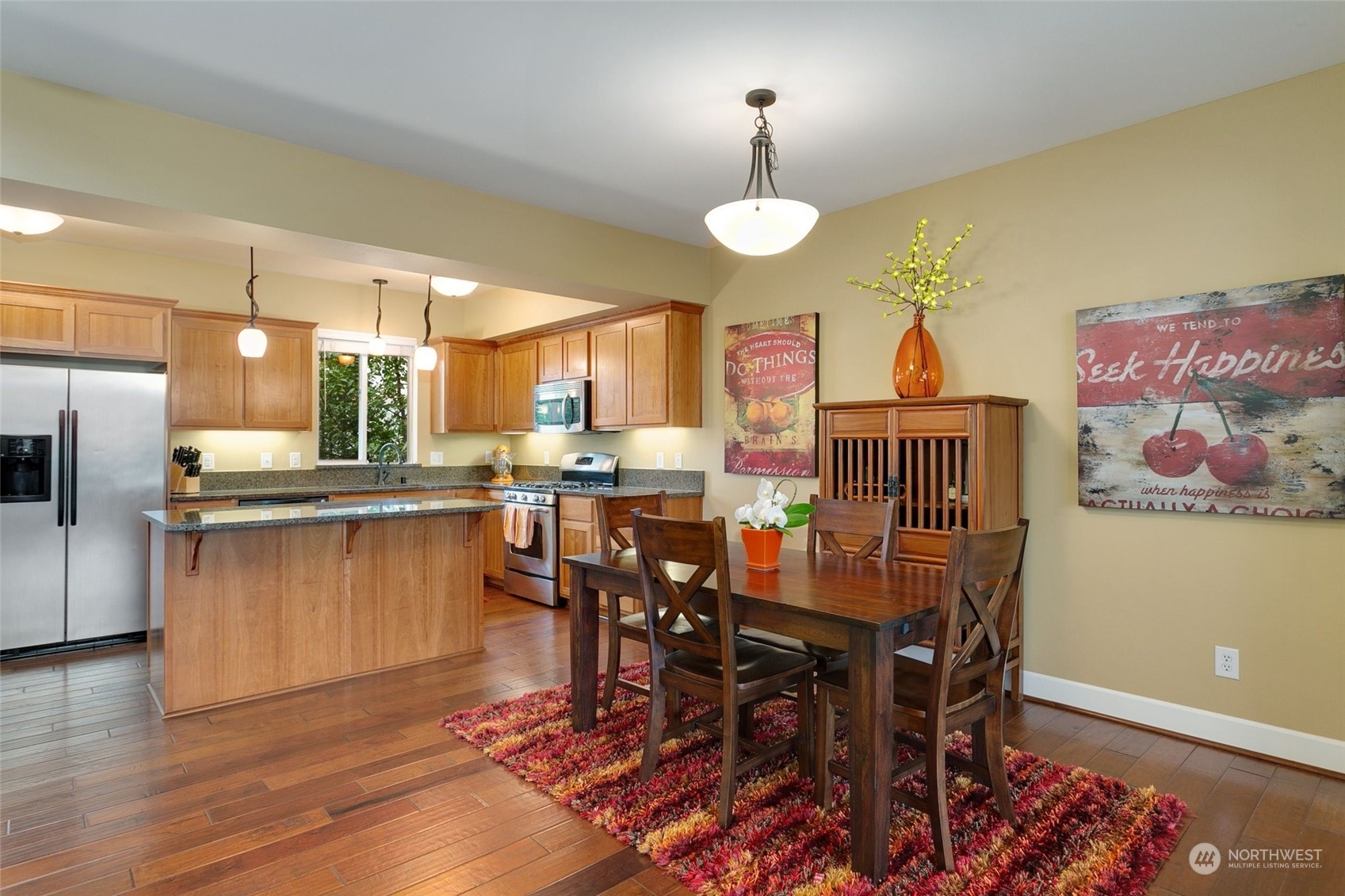4600 Northeast 3rd Lane, Unit E1 Renton, WA 98059 - Photo 5 of 35 a view of a dining room with furniture and wooden floor