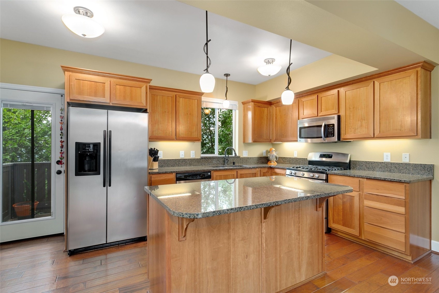 4600 Northeast 3rd Lane, Unit E1 Renton, WA 98059 - Photo 7 of 35 a kitchen with stainless steel appliances granite countertop a sink a stove and refrigerator