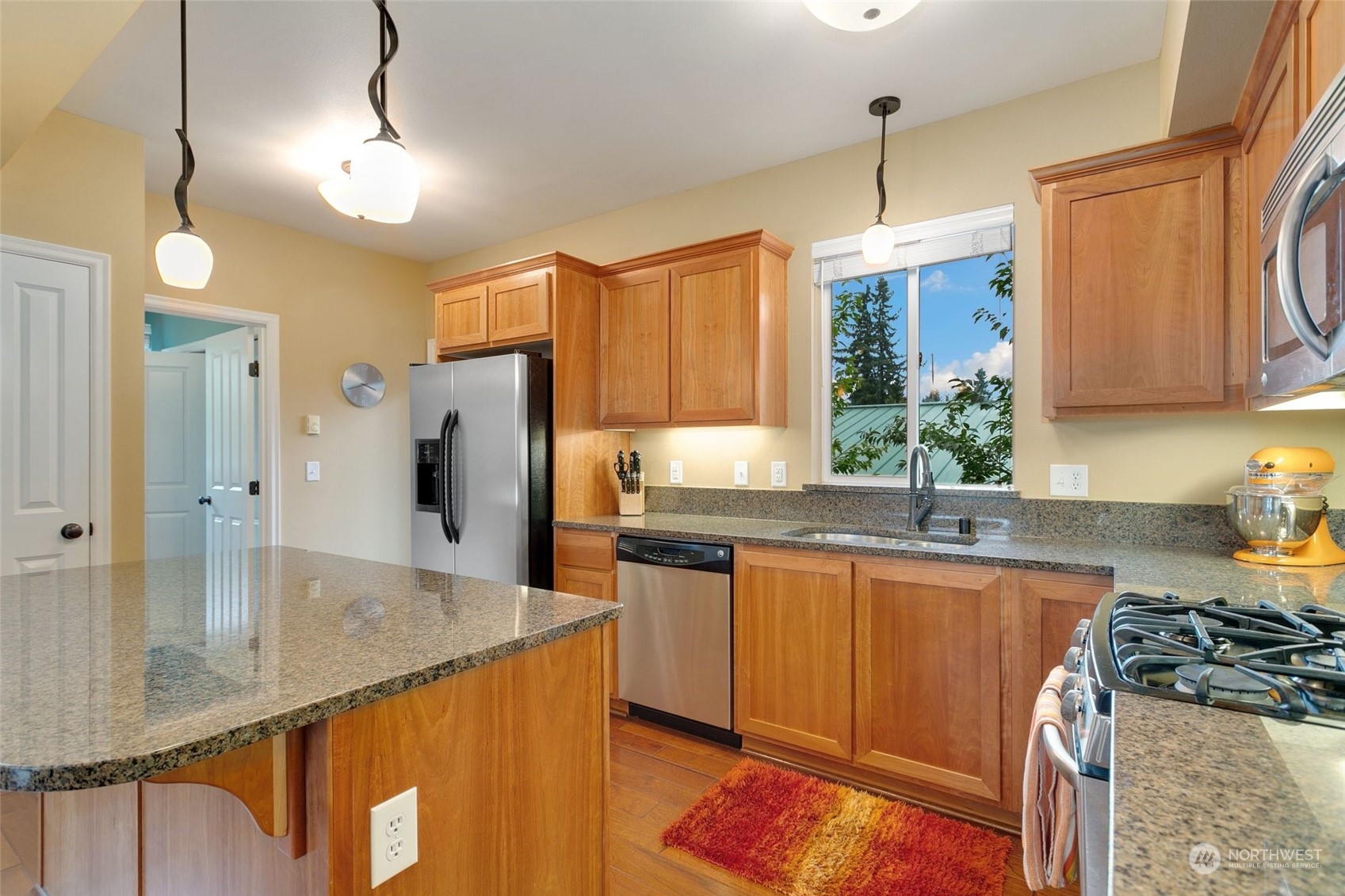 4600 Northeast 3rd Lane, Unit E1 Renton, WA 98059 - Photo 9 of 35 a kitchen with stainless steel appliances granite countertop a sink a stove and a refrigerator