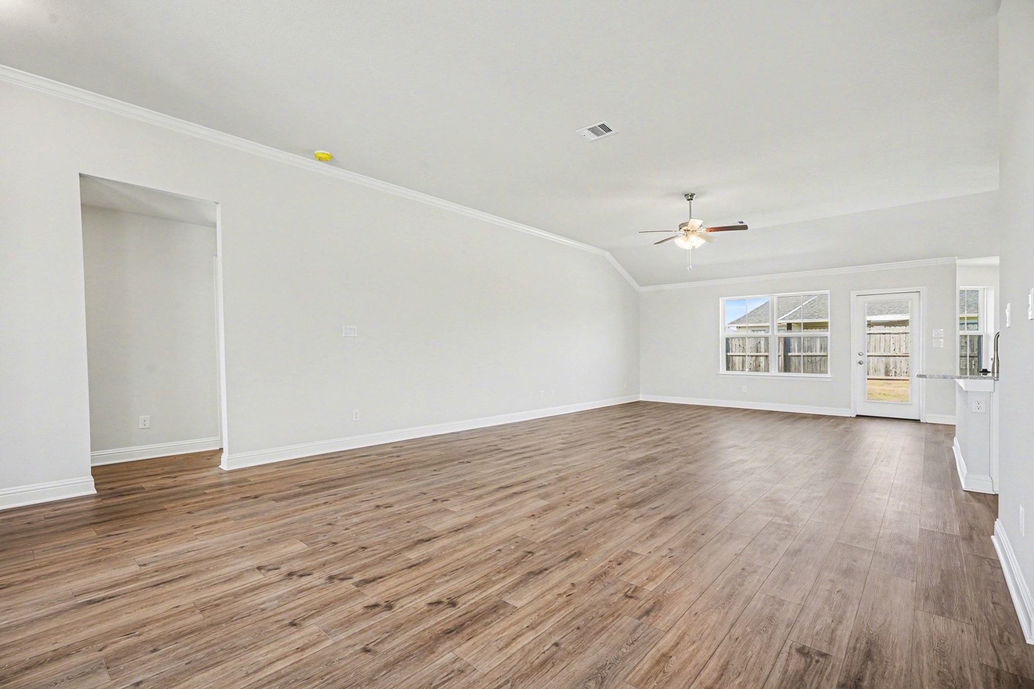 5 Keystone Court Angleton, TX 77515 - Photo 14 of 33 a view of an empty room with wooden floor and a window