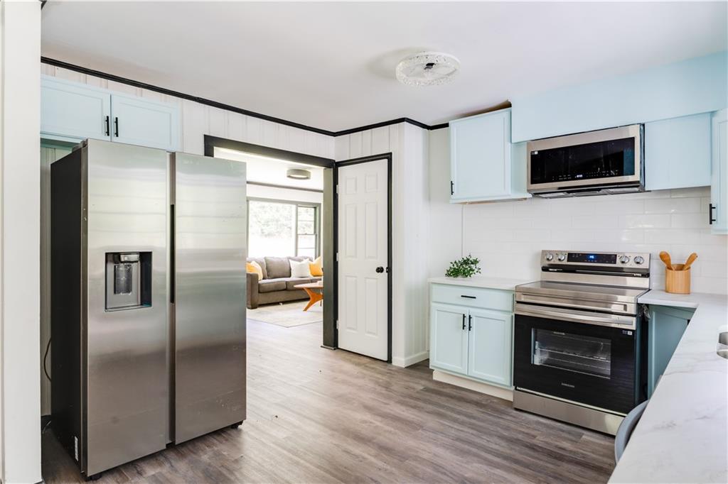 2343 Dawn Drive Decatur, GA 30032 - Photo 14 of 20 a kitchen with stainless steel appliances a refrigerator a stove top oven a sink and dishwasher