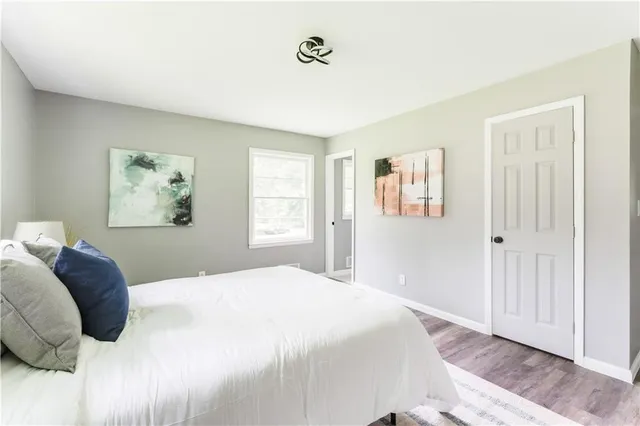 a bedroom with a large bed and a window