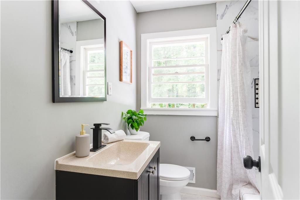 2343 Dawn Drive Decatur, GA 30032 - Photo 20 of 20 a bathroom with a toilet sink and mirror