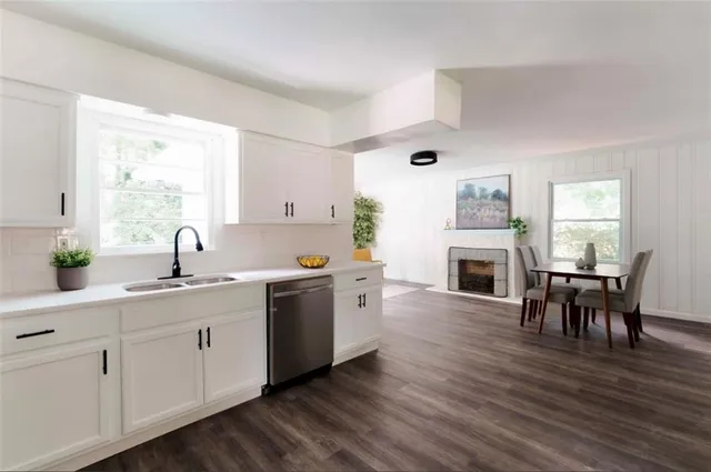 a kitchen with sink cabinets and wooden floor