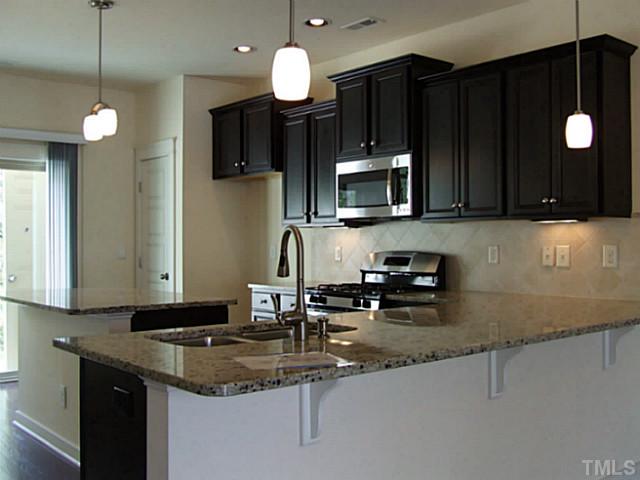 7843 Allscott Way Raleigh, NC 27612 - Photo 2 of 21 Grand kitchen is open and has plenty of space for entertaining!