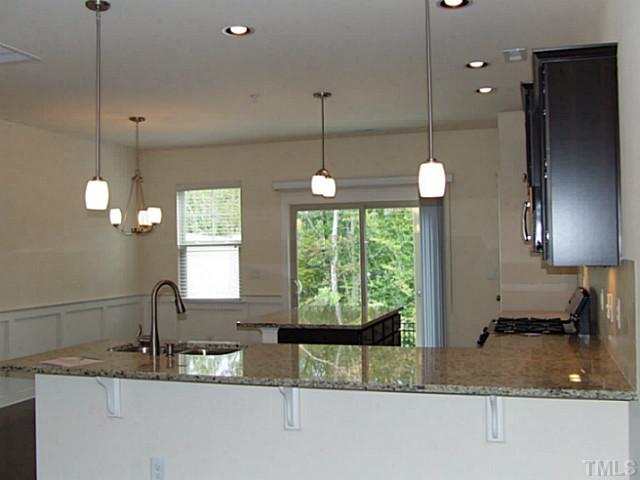 7843 Allscott Way Raleigh, NC 27612 - Photo 3 of 21 granite tops, SS appliances, pendant lights and center island in the kitchen!