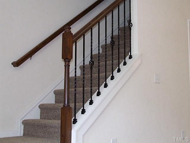 7843 Allscott Way Raleigh, NC 27612 - Photo 6 of 21 wrought iron baluster with oak stained handrail.