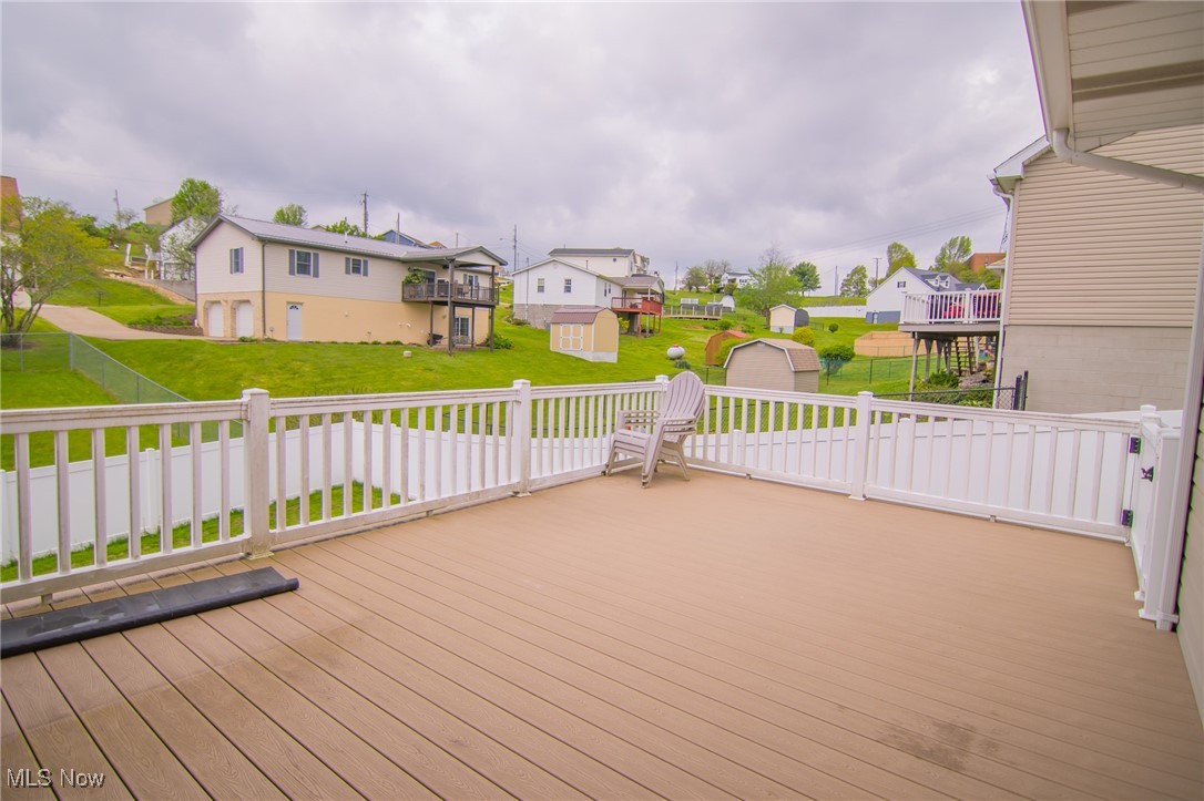 53350 High Ridge Road Bridgeport, OH 43912 - Photo 26 of 37 Wooden deck with a storage shed, an outdoor structure, a residential view, and a lawn