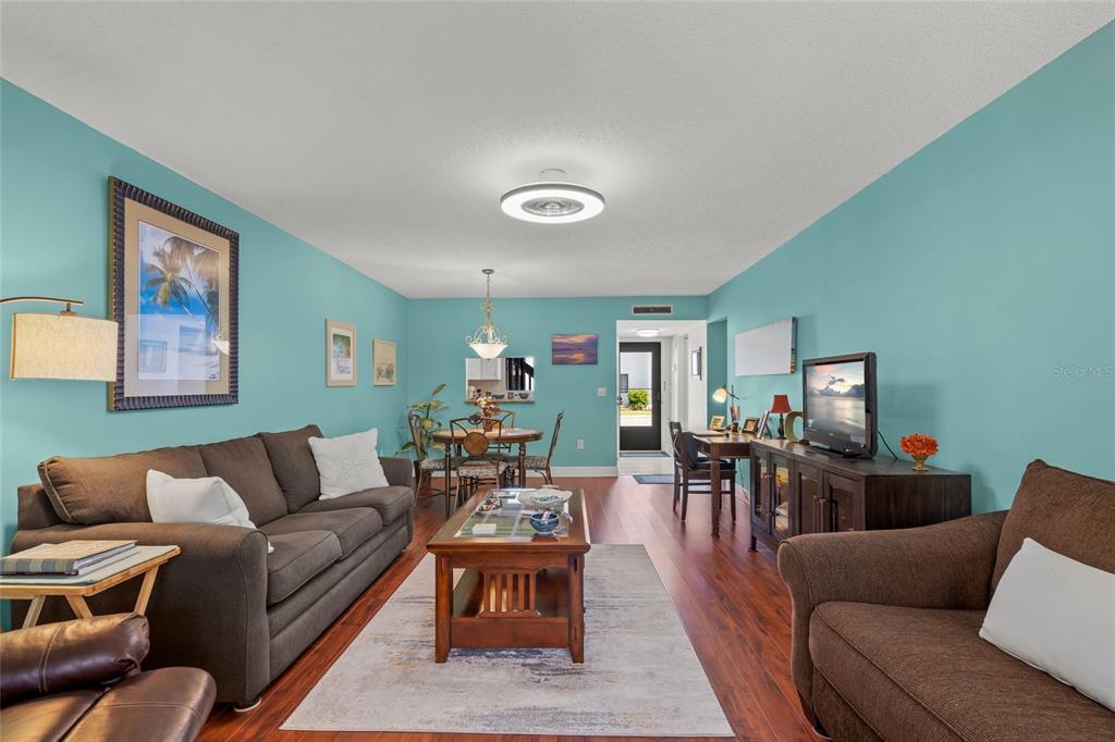 1630 Stickney Point Road, Unit 101 Sarasota, FL 34231 - Photo 14 of 40 a living room with furniture and wooden floor