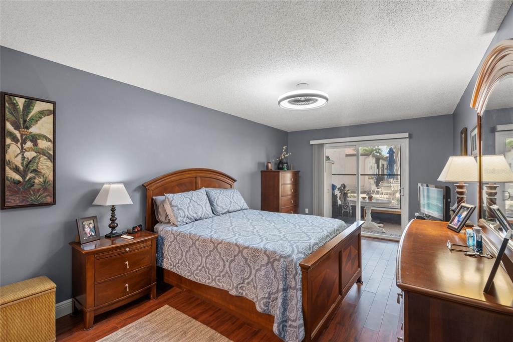 1630 Stickney Point Road, Unit 101 Sarasota, FL 34231 - Photo 15 of 40 a bedroom with a bed and wooden furniture