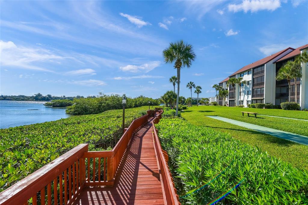 1630 Stickney Point Road, Unit 101 Sarasota, FL 34231 - Photo 30 of 40 a view of a garden with a lake view