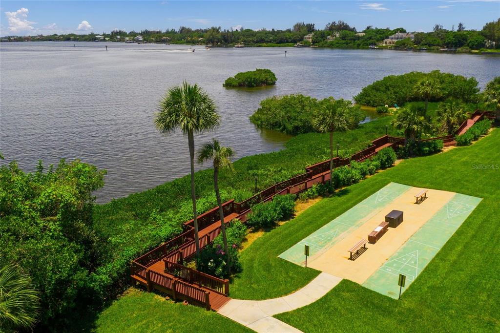 1630 Stickney Point Road, Unit 101 Sarasota, FL 34231 - Photo 34 of 40 a view of a lake with outdoor space and a lake view