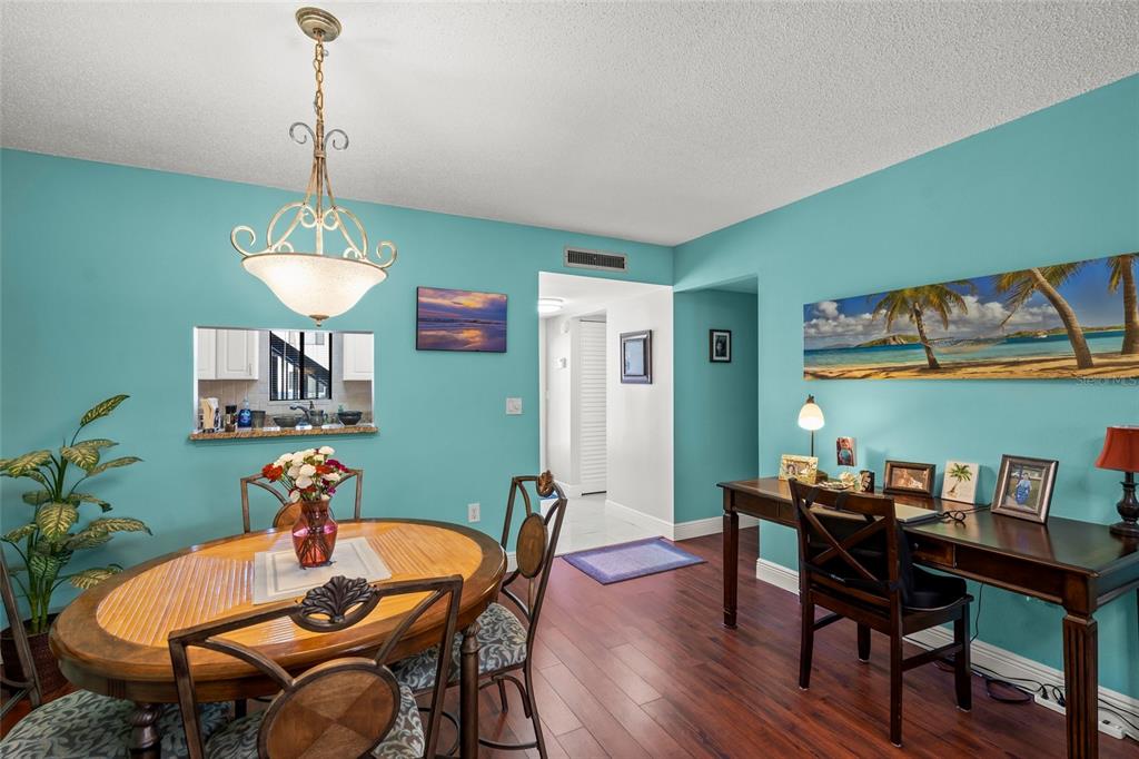 1630 Stickney Point Road, Unit 101 Sarasota, FL 34231 - Photo 7 of 40 a dining room with furniture and window