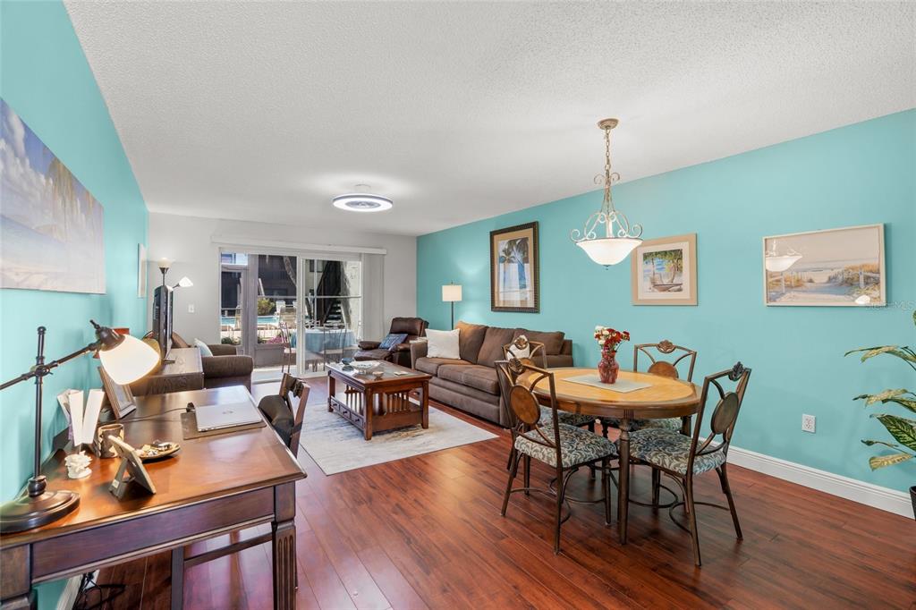 1630 Stickney Point Road, Unit 101 Sarasota, FL 34231 - Photo 9 of 40 a living room with furniture and wooden floor