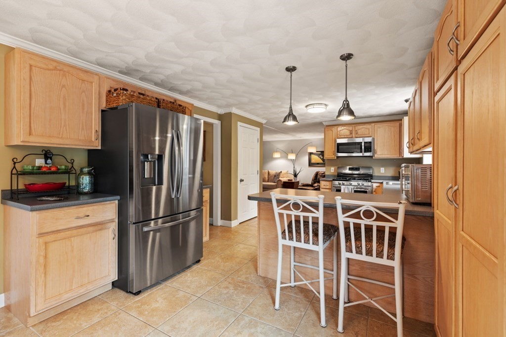 9 Campbell Road Billerica, MA 01821 - Photo 13 of 31 a kitchen with stainless steel appliances a refrigerator a stove a sink and white cabinets