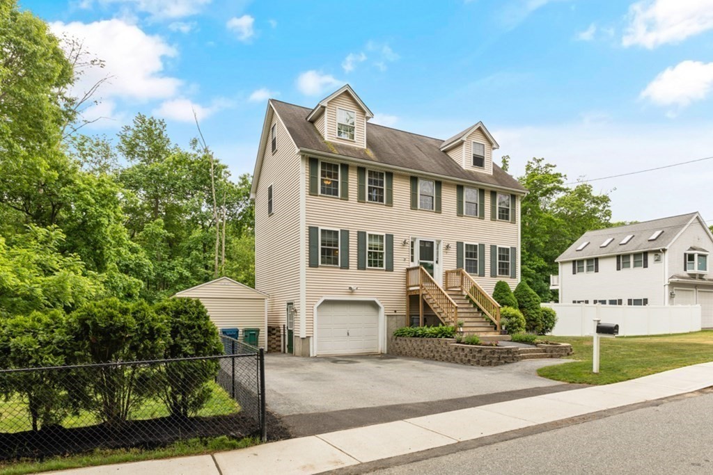 9 Campbell Road Billerica, MA 01821 - Photo 3 of 31 a front view of a building with a garden and plants