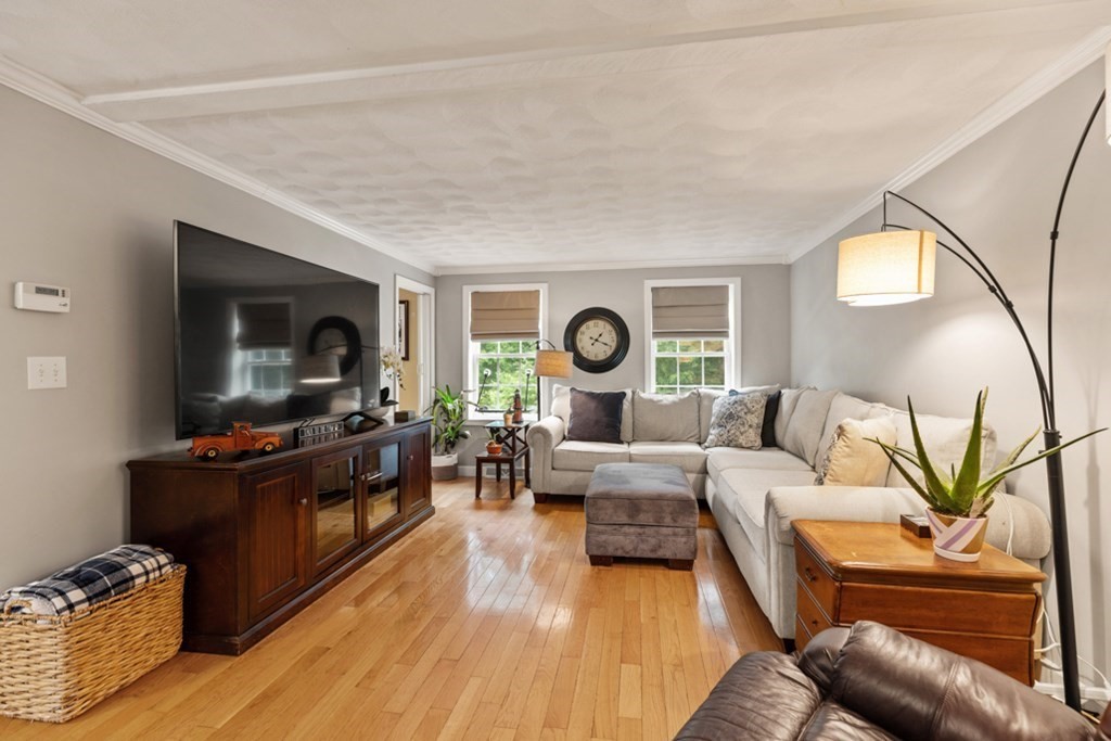 9 Campbell Road Billerica, MA 01821 - Photo 8 of 31 a living room with furniture and a flat screen tv