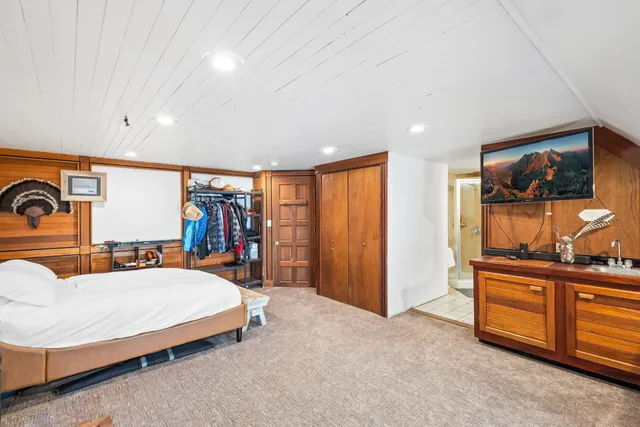 a bedroom with furniture and large window