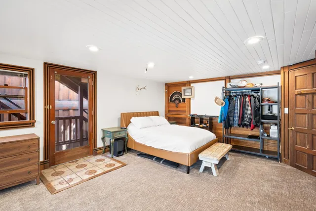 a bedroom with a bed and large window