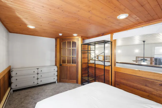 a bedroom with a bed and large window