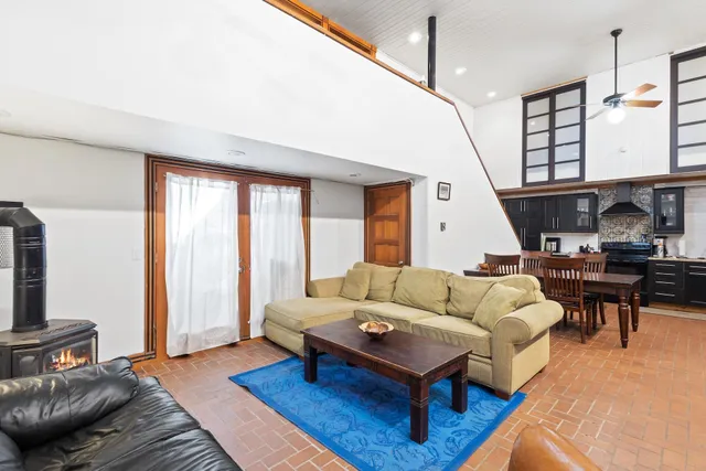 a living room with furniture a rug and a chandelier