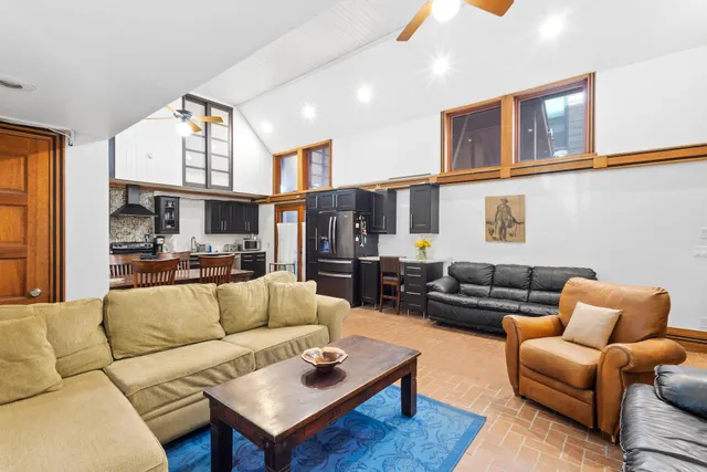 a living room with furniture a rug and a flat screen tv