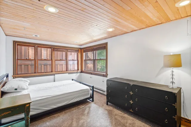 a spacious bedroom with a bed and a window