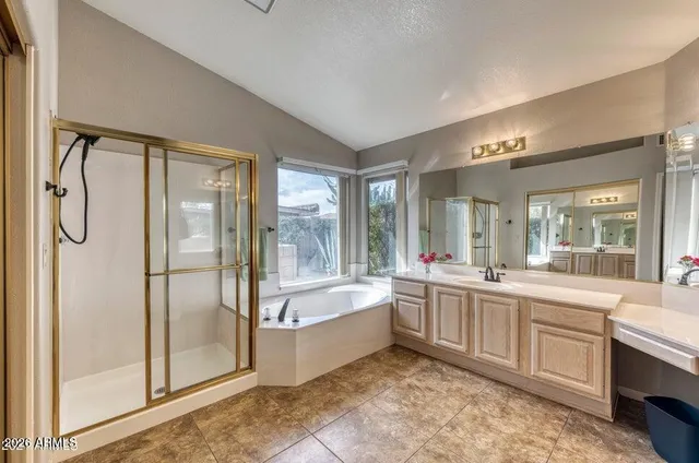 a large en suite bathroom with a tub sink and mirror