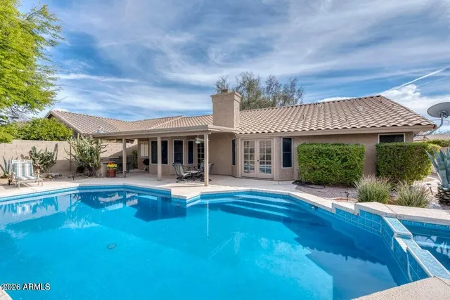 swimming pool view with sitting space and garden view