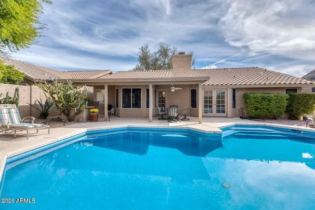 a view of house with swimming pool yard and outdoor seating