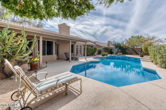 swimming pool view with a outdoor seating