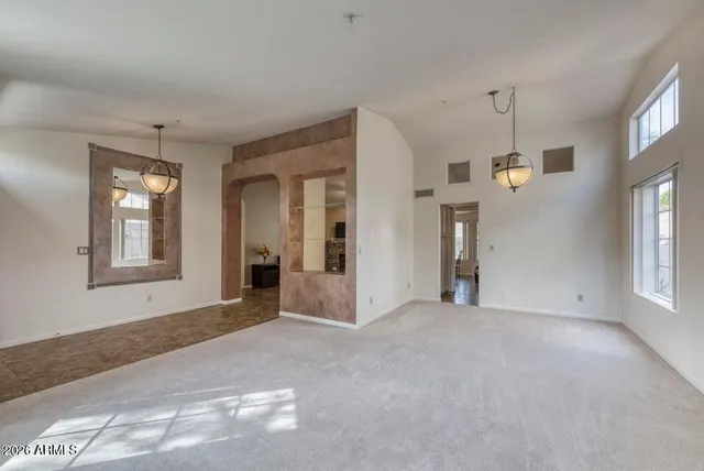 a view of a livingroom with an empty space and window