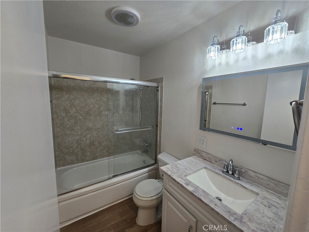 2718 Florida Street, Unit B Huntington Beach, CA 92648 - Photo 11 of 18 a bathroom with a granite countertop sink toilet and shower