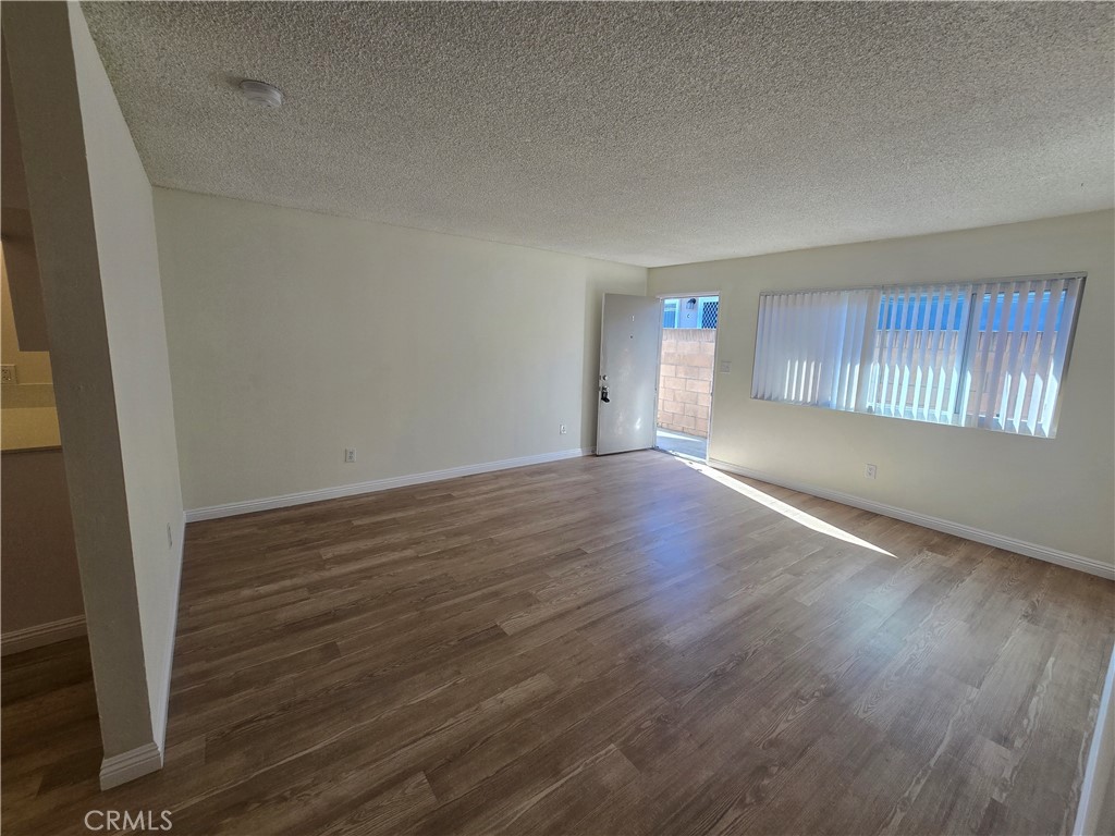 2718 Florida Street, Unit B Huntington Beach, CA 92648 - Photo 16 of 18 an empty room with wooden floor and windows