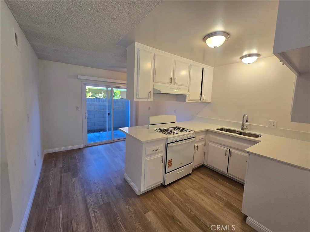 2718 Florida Street, Unit B Huntington Beach, CA 92648 - Photo 17 of 18 a kitchen with wooden floors and sink