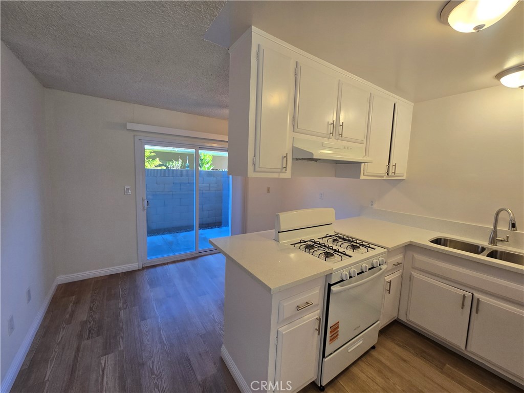 2718 Florida Street, Unit B Huntington Beach, CA 92648 - Photo 5 of 18 a kitchen that has a sink and a stove