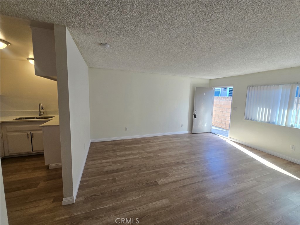 2718 Florida Street, Unit B Huntington Beach, CA 92648 - Photo 7 of 18 a view of a kitchen cabinets and wooden floor