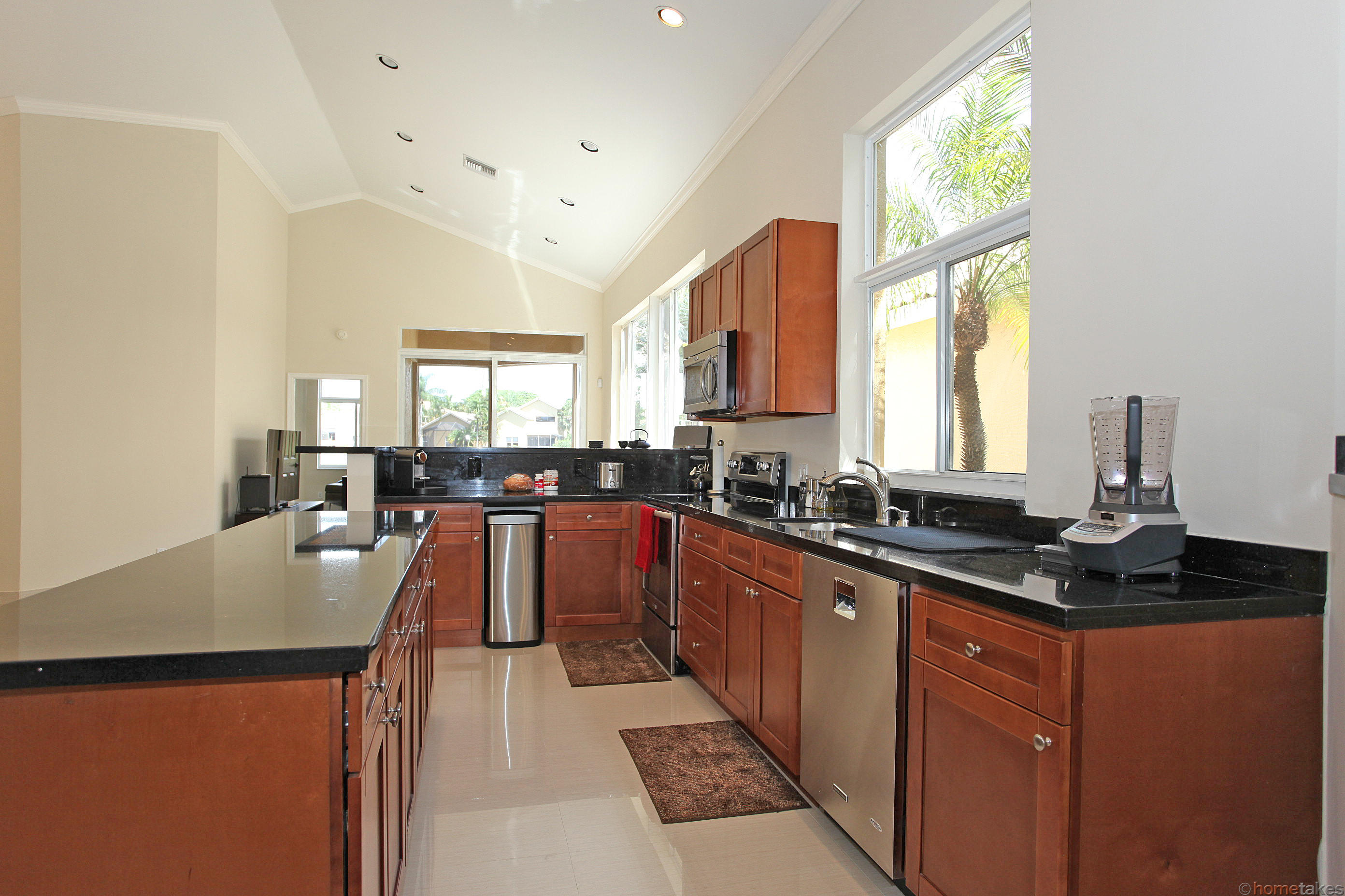 2469 Northwest 66th Drive Boca Raton, FL 33496 - Photo 13 of 15 a kitchen with granite countertop a sink counter top space and living room