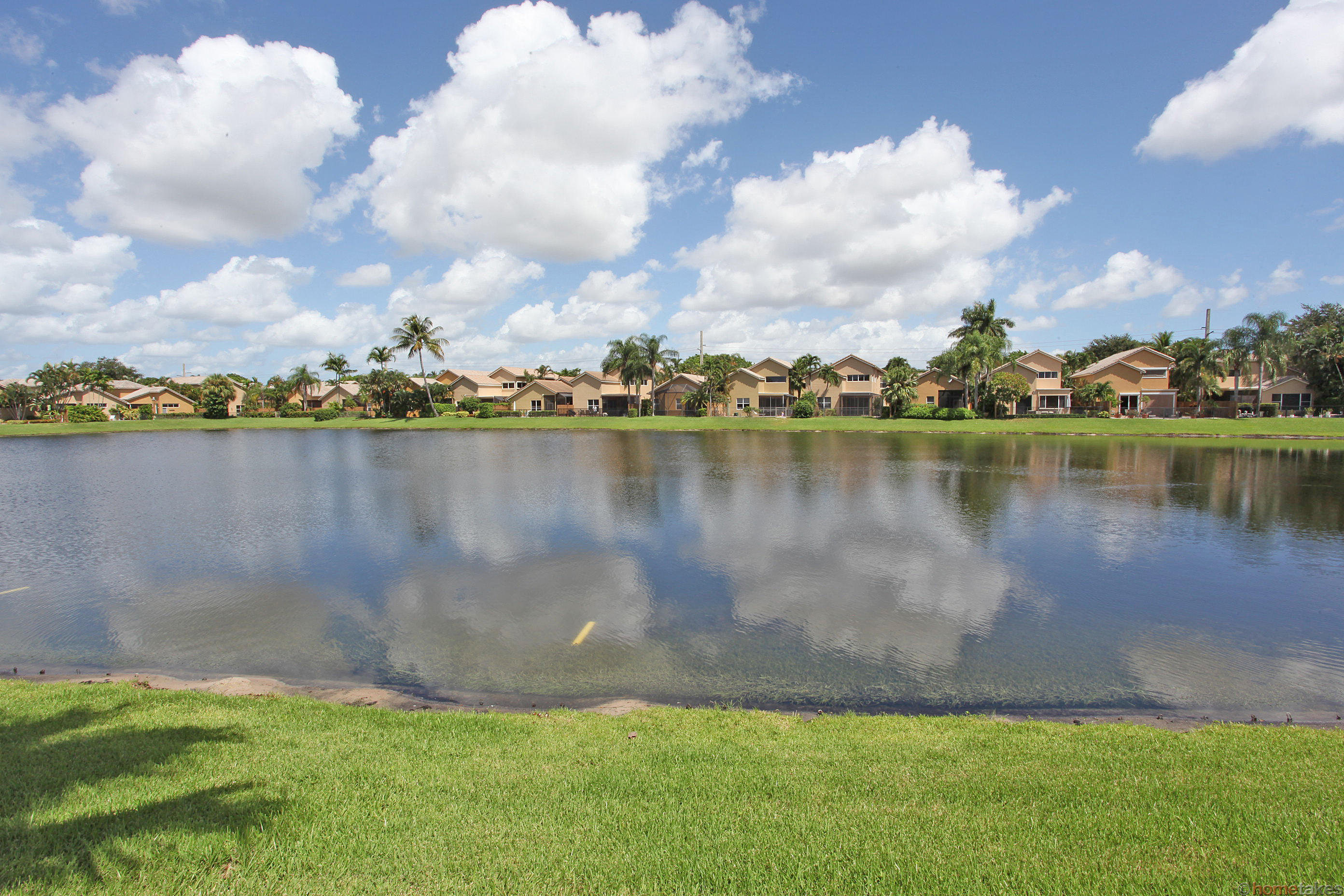2469 Northwest 66th Drive Boca Raton, FL 33496 - Photo 14 of 15 a view of a lake with houses in the back