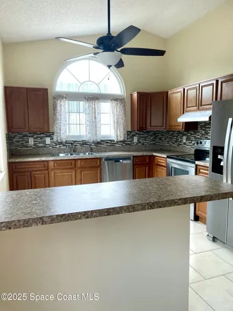 a kitchen with granite countertop a stove a sink and a granite counter tops