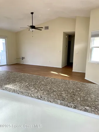 a view of a room with an empty space and window