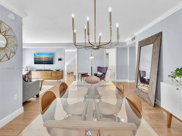 a living room with furniture a fireplace and a chandelier