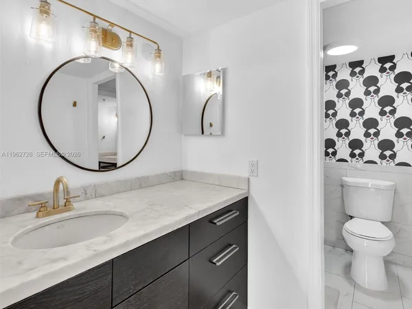 a bathroom with a sink a mirror and a toilet