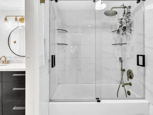 a bathroom with a bath tub and a shower