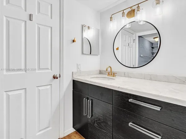 a bathroom with a sink vanity and a mirror