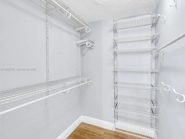a view of walk in closet with empty racks