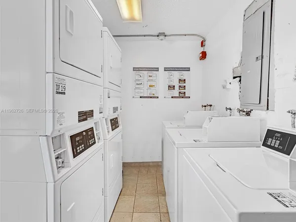 a utility room with cabinets washer and dryer