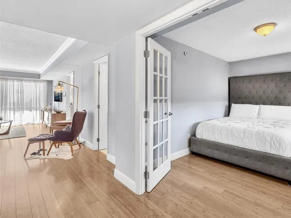 a bedroom with furniture and a wooden floor