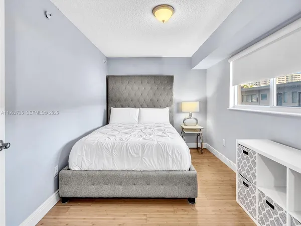 a living room with a bed furniture and a window