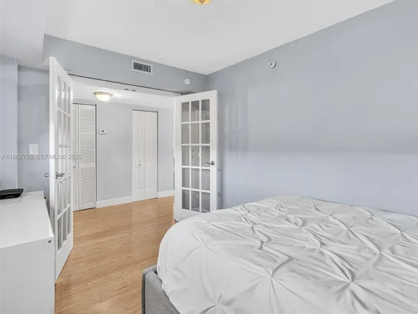 a large white bed in a white room